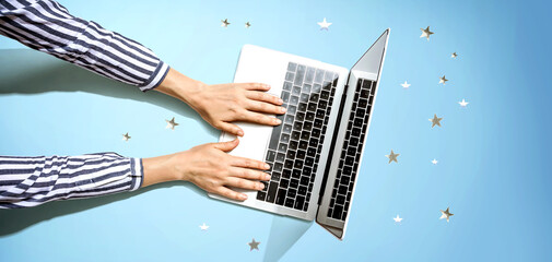Person using a laptop computer with small stars from above