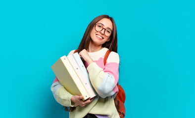 young pretty woman feeling happy, positive and successful, motivated when facing a challenge or...