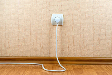 The white plug with a wire is connected to a white socket