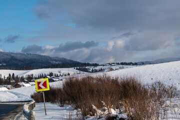 Winter in the mountains. Panorama, blue sky, clouds. 