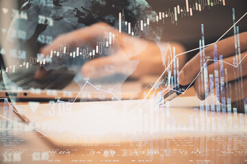 Stock market analysis concept with financial chart and graphs and man hand making notes. Double exposure