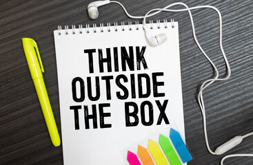 Think Outside The Box appearing behind torn brown paper.