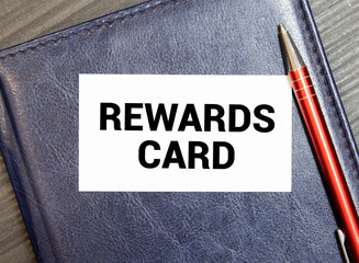 Businessman putting a card with text REWARD PERFORMANCE in the pocket.