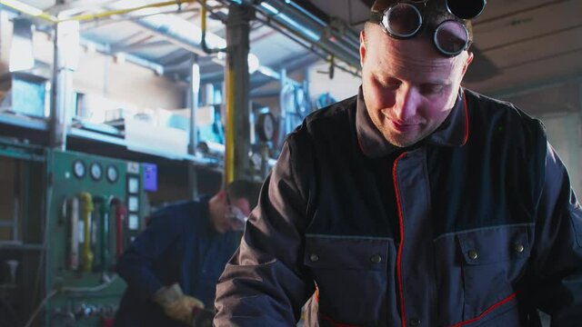 Welder working with autogenous welding tool in workshop