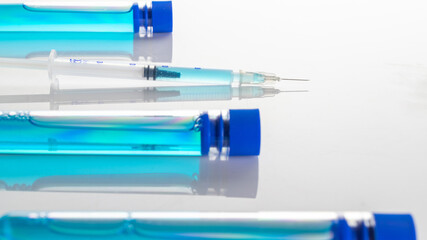 Vaccine vial. Medical syringe with needle for protection flu virus and coronavirus. Covid inoculation on white. Close up vaccine vial dose flu shot drug needle syringe.