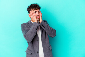 Young caucasian man isolated on blue background whining and crying disconsolately.