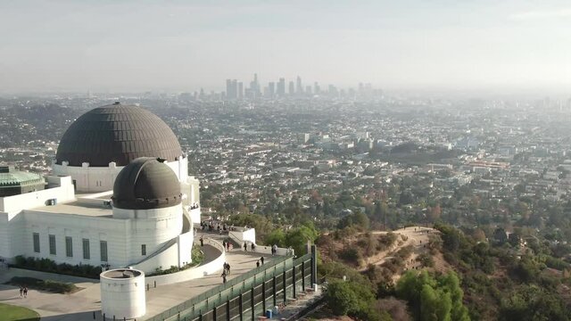 Aerial drone view of Griffith Park, Observatory at Sunset. downtown Los Angeles skyline. California travel destination in America.