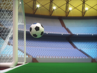 Soccer ball entering the goal inside a sports stadium with the grandstand in the background.