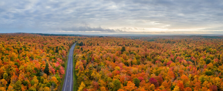 Sunset Autumn drive through the tunnel of Trees in Michigan Upper Peninsula UP - Highway 41 M26 Aerial view