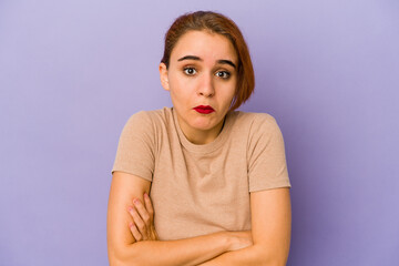 Young arab mixed race woman shrugs shoulders and open eyes confused.