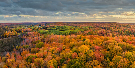 Sunset autumn aerial views on the drive through the tunnel of Trees in Michigan Upper Peninsula UP...