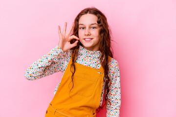 Little caucasian girl isolated on pink background cheerful and confident showing ok gesture.