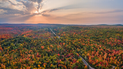 Sunset Autumn drive through the tunnel of Trees in Michigan Upper Peninsula UP - Highway 41  M26...