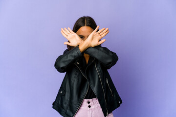 Young mixed race woman keeping two arms crossed, denial concept.