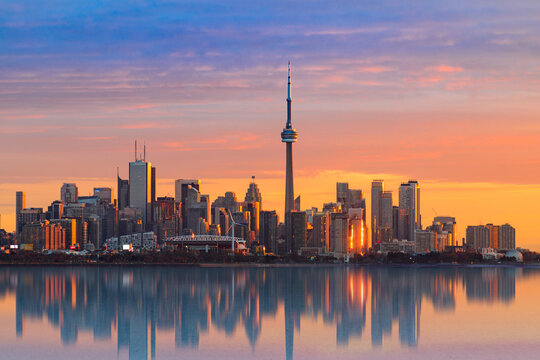 SUNRISE IN TORONTO CANADA REFLEXING IN THE WATER - Powered by Adobe