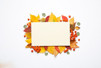 Flat lay composition with autumn leaves and blank card on white background, space for text