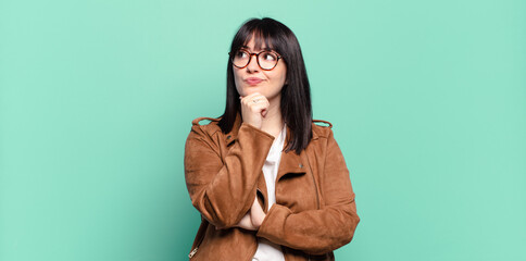 plus size pretty woman thinking, feeling doubtful and confused, with different options, wondering...