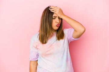Young indian woman isolated on pink background forgetting something, slapping forehead with palm...