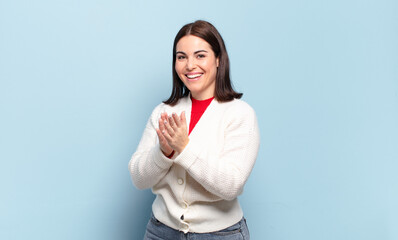 young pretty casual woman feeling happy and successful, smiling and clapping hands, saying...