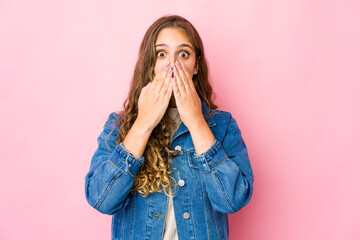 Young caucasian woman shocked covering mouth with hands.