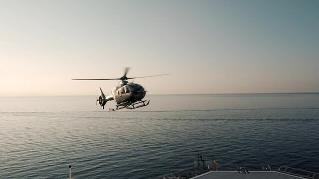 Jet helicopter landing on large super yacht heli deck at sea. Filmed in 200fps for excellent cinematic slow motion.