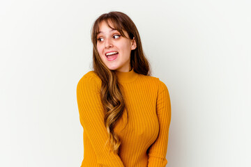 Young caucasian cute woman isolated on white background looks aside smiling, cheerful and pleasant.