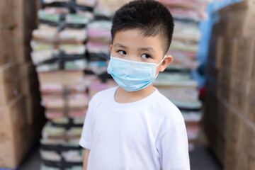 Portrait of little Asian boy wearing mask for protect pm2.5 pollution and coronavirus