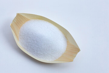 White granulated sugar on white background.