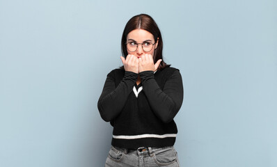young pretty casual woman looking worried, anxious, stressed and afraid, biting fingernails and...
