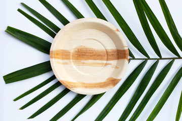 Betel palm leaf plate on white background.