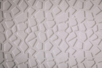 White wall with a polygonal pattern, close up