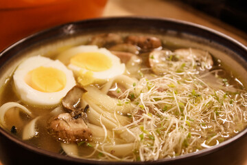 Ramen with boiled eggs, sprouts, and mushrooms