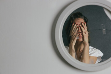 Reflection of a woman's face in broken mirror. Depression, anxiety, phobia, suicide and mental...