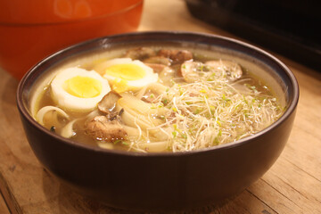 Ramen with boiled eggs, sprouts, and mushrooms