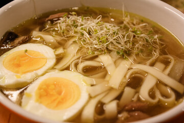 Ramen with boiled eggs, sprouts, and mushrooms