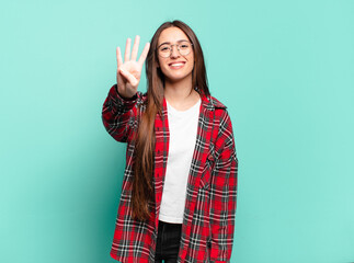 young pretty casual woman smiling and looking friendly, showing number four or fourth with hand...