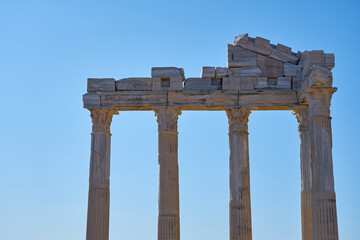 Fototapeta premium The ruins of the Apollo temple in Side, Turkey against a blue sky.