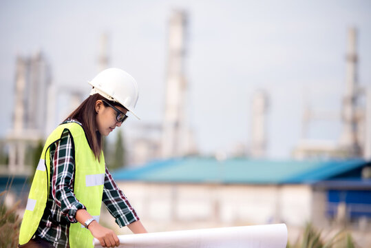  Asian engineer on construction site check documents plan on construction site ,Industry ,Engineer and safety concept . 
