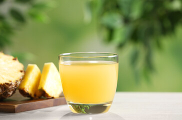 Freshly made pineapple juice in glass on table