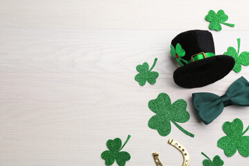 Flat lay composition with leprechaun hat on white wooden table, space for text. St Patrick's Day...