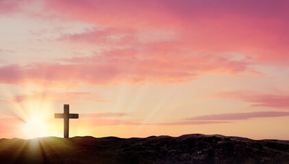 Christian cross on hill outdoors at sunrise. Resurrection of Jesus