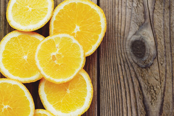 Fototapeta na wymiar Fresh orange fruits slices on wooden background, Orange peel