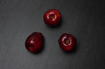 Red apples on a dark table