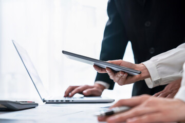 business people holding tablet and smartphone with meeting and brainstorming in planning work.