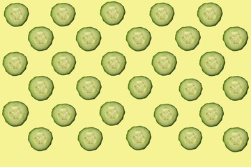 Fresh cucumber cut into circles on a yellow background. Background.