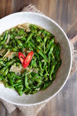 a plate of sauteed limnocharis flower or sawah-lettuce flower on the table  