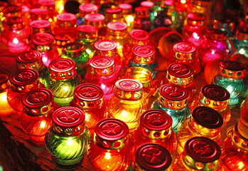 Fototapeta premium a lot of shiny colorful candles. blurred image