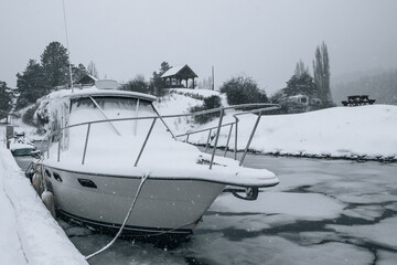 boat covered in snow in a marina on Vancouver Island, British Columbia, Canada on a winter day
