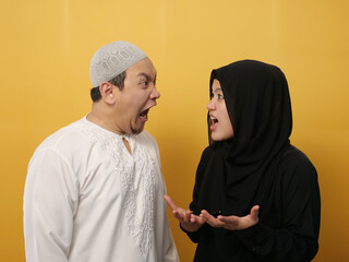 Asian muslim couple husband and wife having fight, argue and screaming on each other, bad relationship in marriage