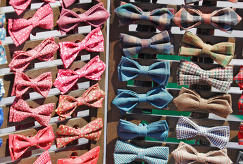 men's bow ties on the wooden counter